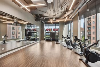 a workout room with weights and yoga machines and a large window  at Cassidy on Canal, Chicago, Illinois